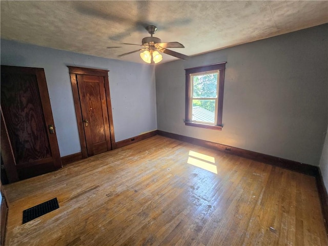 unfurnished bedroom featuring light hardwood / wood-style flooring and ceiling fan