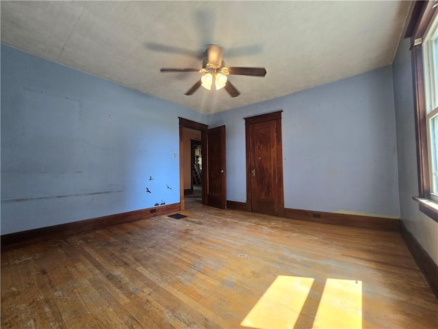 spare room with light wood-type flooring and ceiling fan