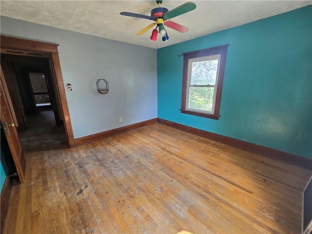 empty room with ceiling fan and hardwood / wood-style flooring