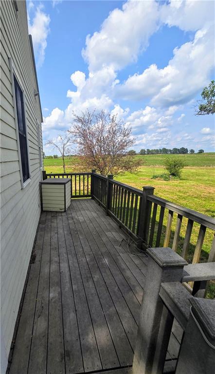 wooden deck featuring a rural view