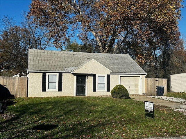 ranch-style home featuring a garage and a front yard