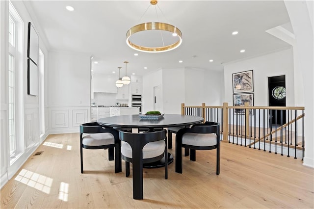 dining area featuring light wood-type flooring