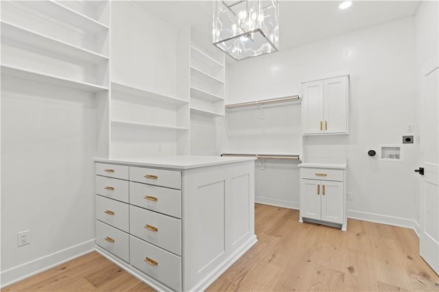 walk in closet featuring light hardwood / wood-style flooring