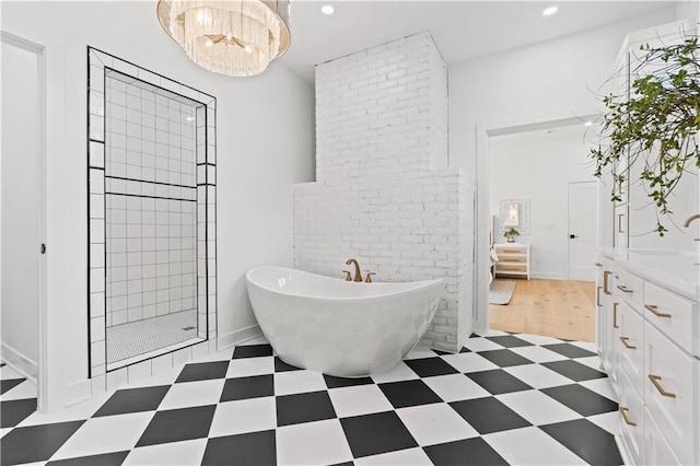 bathroom with shower with separate bathtub, sink, a notable chandelier, and hardwood / wood-style floors