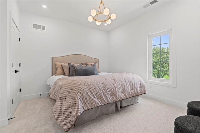 bedroom featuring light carpet and an inviting chandelier