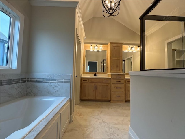 bathroom featuring an inviting chandelier, lofted ceiling, vanity, and a tub