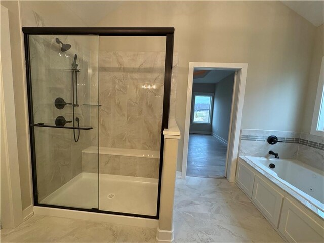 bathroom with separate shower and tub