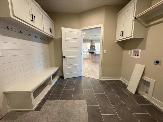 mudroom featuring dark tile patterned floors