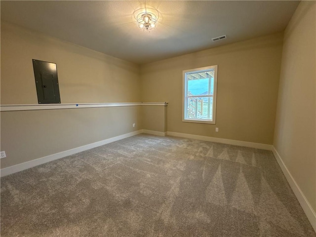 empty room featuring electric panel and carpet floors