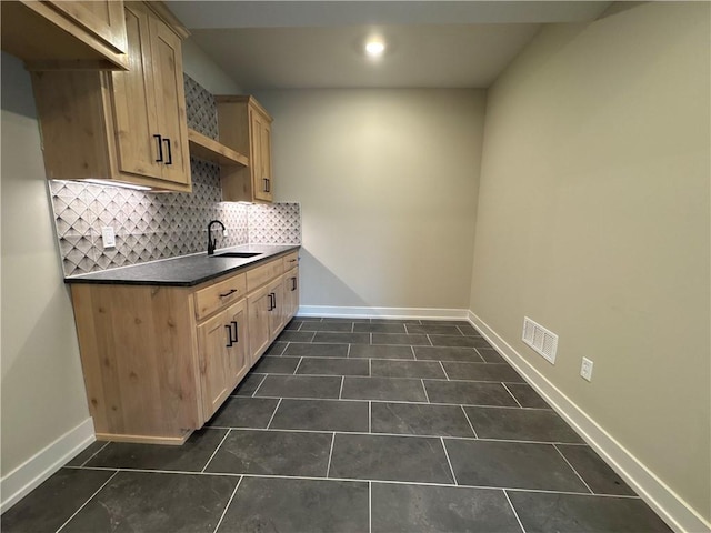 12870 N Champanel Way, Platte City, MO 64079 - kitchen with dark countertops, decorative backsplash, dark tile patterned floors, light brown cabinets, and recessed lighting