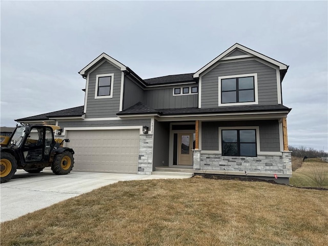 view of front of home featuring a garage, covered porch, and a front lawn