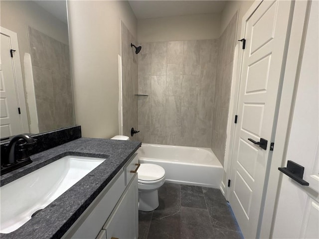 full bathroom with tiled shower / bath, vanity, and toilet