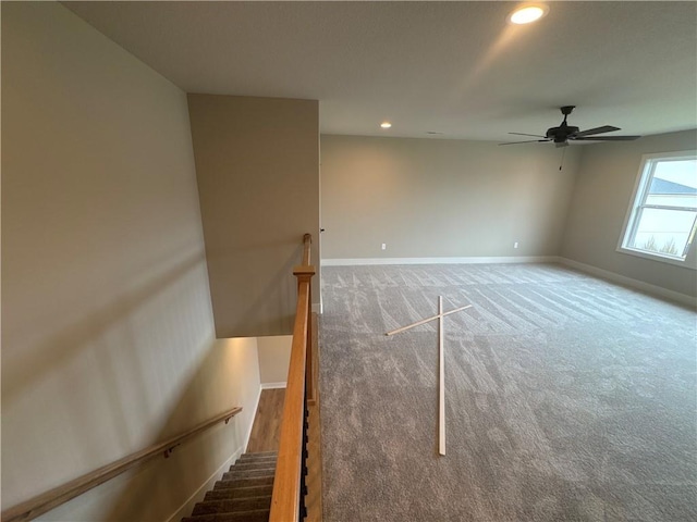 carpeted spare room with ceiling fan