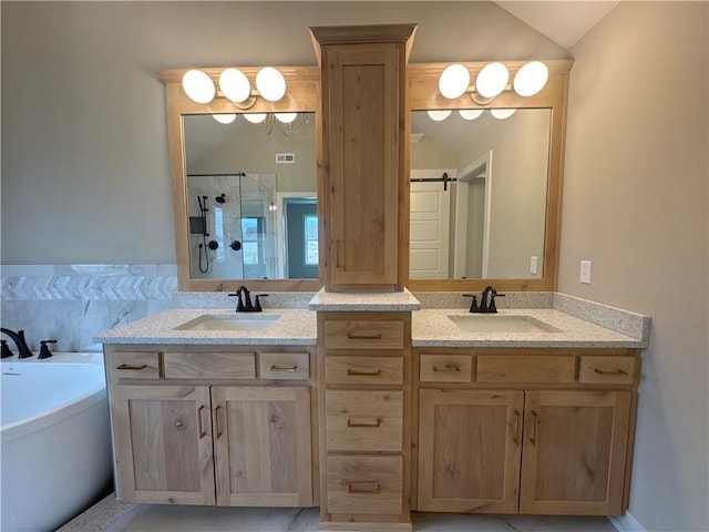 bathroom featuring lofted ceiling, vanity, and shower with separate bathtub