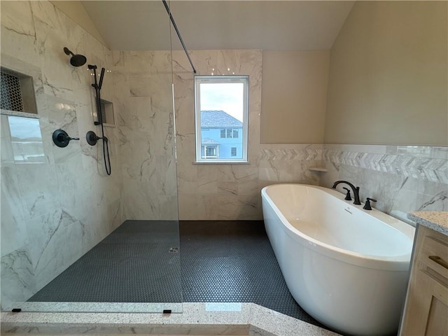 bathroom with lofted ceiling, vanity, plus walk in shower, and tile walls