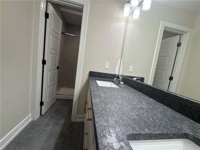 bathroom with vanity, tile patterned flooring, and a shower