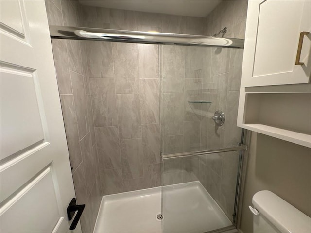 bathroom with toilet and walk in shower