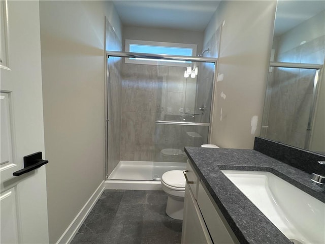 bathroom with vanity, toilet, and a shower with door