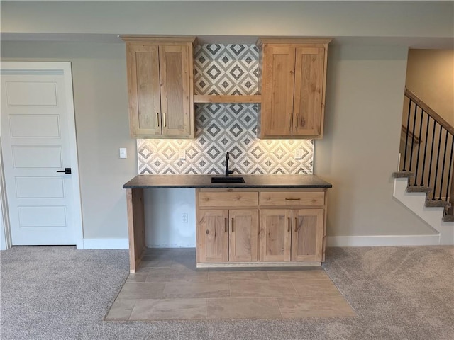 kitchen with light colored carpet, sink, and decorative backsplash