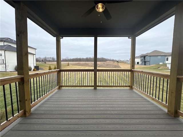 wooden deck featuring ceiling fan and a lawn