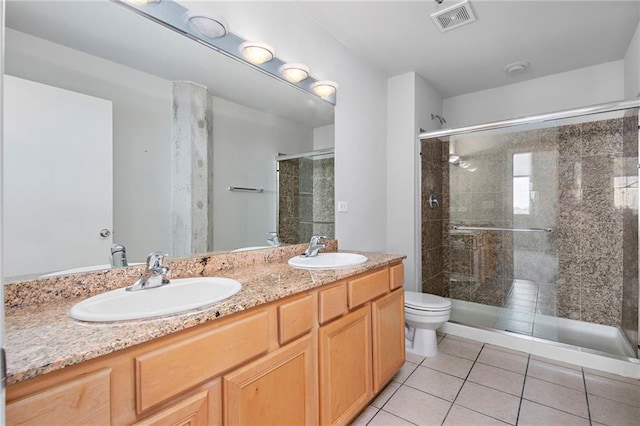 bathroom featuring an enclosed shower, tile patterned flooring, toilet, and double sink vanity