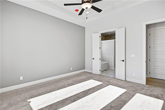 unfurnished bedroom with ceiling fan, carpet, and ensuite bathroom