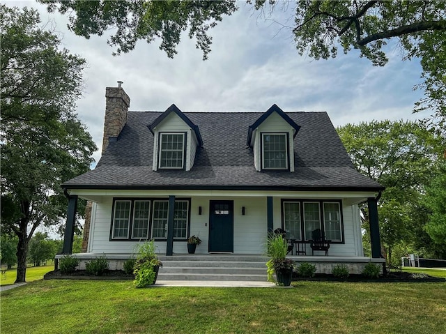 cape cod-style house featuring a porch and a front lawn