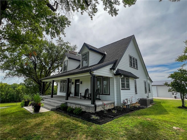 view of front of home with a front yard, central air condition unit, and a porch