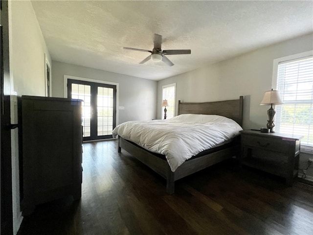 bedroom with ceiling fan, dark hardwood / wood-style floors, a textured ceiling, access to outside, and french doors