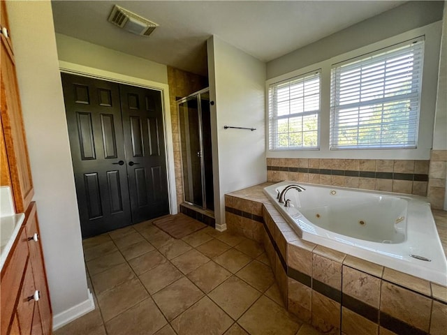 bathroom featuring independent shower and bath and tile patterned flooring