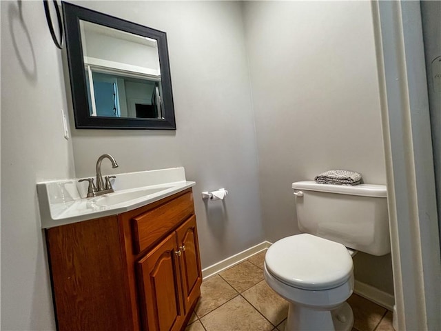 bathroom with vanity, tile patterned floors, and toilet