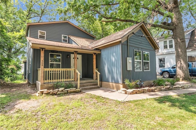 view of front of home with a front yard and covered porch