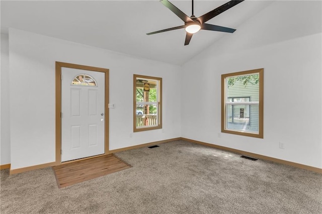 carpeted foyer entrance with lofted ceiling and ceiling fan