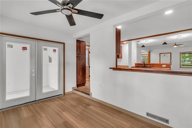 interior space featuring light hardwood / wood-style flooring, sink, and ceiling fan