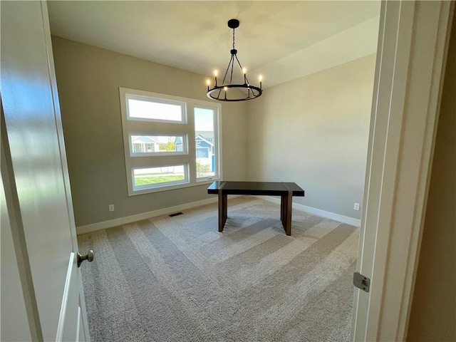 interior space featuring a chandelier and light carpet