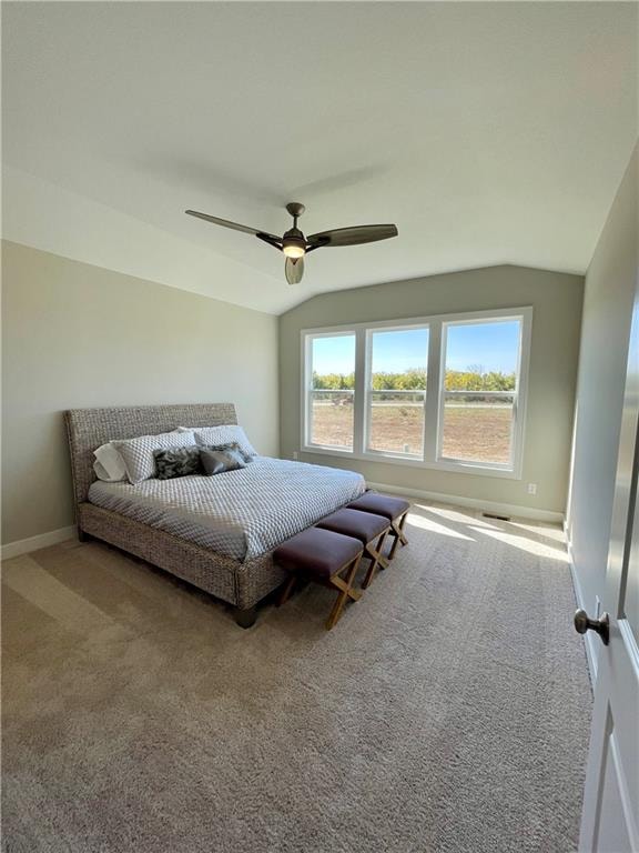 bedroom featuring lofted ceiling, carpet, and ceiling fan