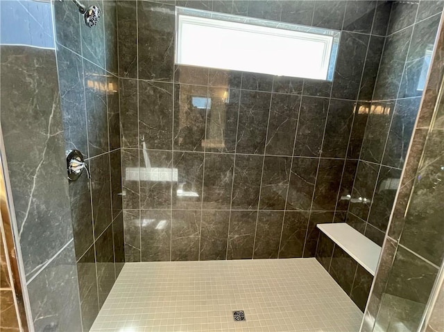 bathroom with a tile shower