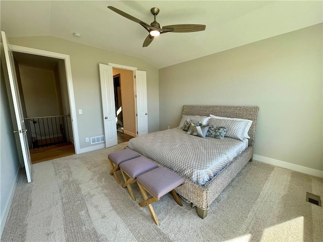 carpeted bedroom featuring lofted ceiling and ceiling fan