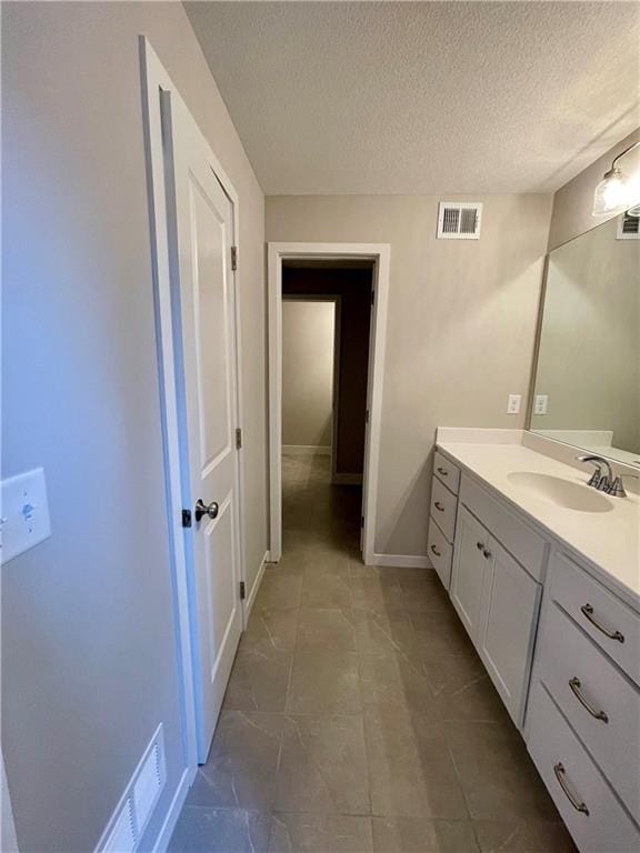 bathroom with vanity and a textured ceiling