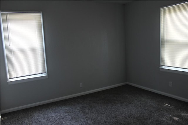 carpeted spare room with plenty of natural light