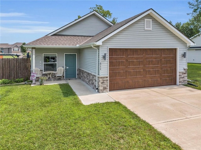 view of front of home with a garage and a front yard