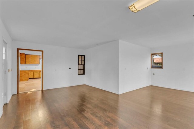 unfurnished room with hardwood / wood-style flooring