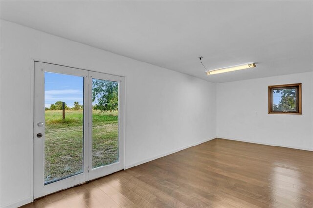 unfurnished room featuring hardwood / wood-style flooring