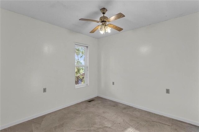 empty room featuring light colored carpet and ceiling fan