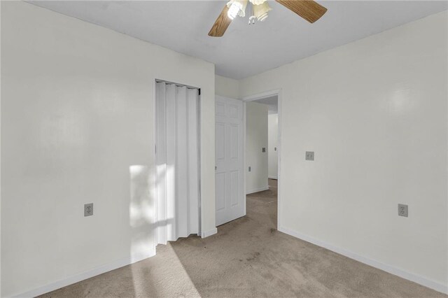 carpeted empty room with ceiling fan