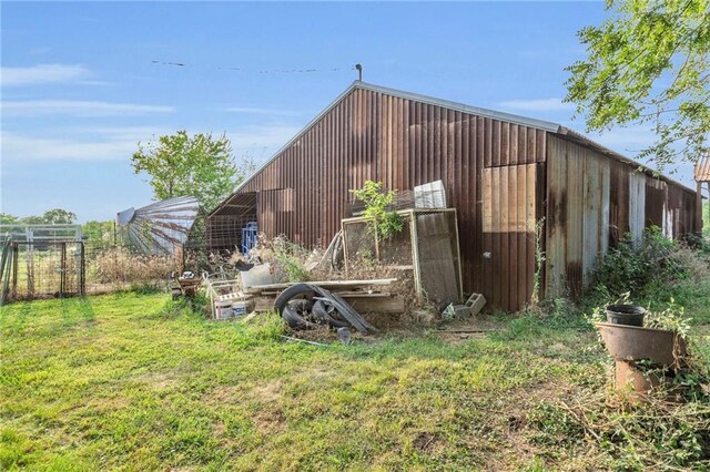 view of outbuilding featuring a lawn