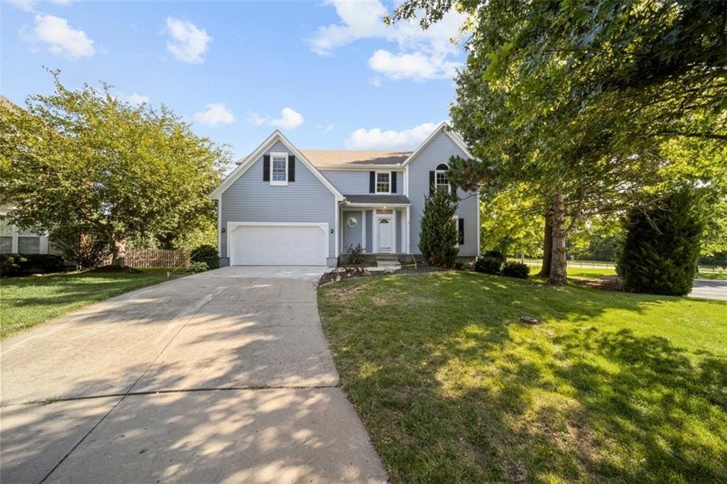 view of front facade with a garage and a front lawn