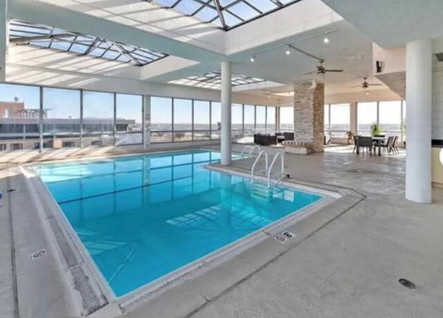 community pool featuring a lanai and a patio