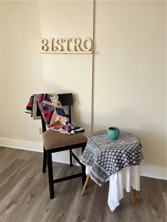 interior space with baseboards and dark wood-type flooring