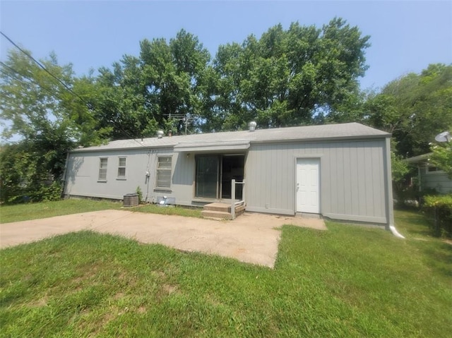 rear view of house with a patio area and a lawn